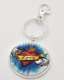 Dress your keys up with this funky keychain! It features a flaming red heart with wings wrapped in a “Love” banner, flying through a blue sky. The tight-fitting clasp keeps your keys close together and organized. Its unique design makes it fit nicely in your pocket or purse, or attach it to a belt loop on your jeans to make a fashion statement! 