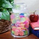 Personalized Worlds Greatest Teacher Treat Jar - Engraved Teacher Goodies Treat Jar Give your favorite teacher a lovely, personalized teacher gift which will look great in the classroom or at home. Our Personalized Worlds Greatest Teacher Treat Jar is perfect for storing classroom rewards including stickers, candy or little play toys. Your Engraved Teacher Treat Jar measures 7" h x 4" w and holds 31 oz. Each glass jar comes with an air-tight glass lid. Contents displayed in glass jar not included. Includes FREE Engraving. Personalize your Worlds Greatest Teacher Treat Glass Jar with any name. ( ie. Mrs. Young )