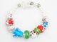 Peace, love and sunshine make this a fun bracelet to give or receive. Silver like beads and colorful glass beads move on the silver toned chain. Fun to wear.