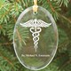 Show your favorite doctor how thankful you are by giving an Engraved Medical Ornament. Each Engraved Medical Keepsake is professionally engraved for optimal presentation and looks wonderful hanging from a Christmas tree or used as a stunning sun catcher hanging on a window. Each Medical Keepsake Ornament measures 3.75" x 2.75" and includes a golden ribbon loop and Free Gift Pouch. This glass engraved ornament is laser etched with the Caduceus symbol and any persons name.