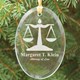Present your Attorney or New Law Graduate with this attractive Engraved Lawyer Ornament Keepsake. Each Engraved Lawyer Ornament makes a unique gift for him or her and looks great at the office, home or hanging from the Christmas tree. Our Personalized Lawyer Ornament makes a wonderful keepsake that is enjoyed every day. Each Lawyer Keepsake Ornament measures 3.75" x 2.75" and includes a golden ribbon loop and Free Gift Pouch. This glass engraved ornament is laser etched with Attorney at Law and any persons name.