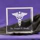 A wonderful gift for a doctor, nurse, or med students. This Tiny Treasure is engraved with a caduceus symbol, and the recipients name. These adorable keepsake blocks come with a velvet pouch to keep them dust free. Blocks measure 2 1/2" x 2 1/2" and are 1" thick, so they can stand on their own. 
