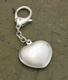 If there were a key to your heart, this would be the perfect place to keep it! Our personalized heart-shaped silver-plated key chain is not only ideal for holding keys but can also be hung on a purse or other accessory. The easy-to-open clasp makes this key chain simple to use and a short chain keeps it out of the way. Perfect as an elegant wedding favor, too! Measures 4 1/8" x 1/8".
