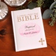 Our Personalized Pink Baptized Catholic Childs First Bible is an excellent introduction to Gods word and helps the Catholic child learn more about his/her faith. Written in simple prose and with easy-to-read text and vibrant illustrations, this Bible boasts a soft white vinyl cover with choice of colorful design. With gold stamping, edging and ribbon, it is perfect for daily reading or reading together. A great gift for any religious occasion! With 96 gilded pages, the childrens sized bible measures 6x9 and includes gift box. 