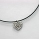 This simple heart necklace on a 18" leather cord is a very fun and trendy look. Available with a red leather cord or black leather cord.