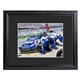 Perfect for the Man Cave, an office or family room. Complete with a personal message from his favorite driver. Framed in black and also includes recipients last name on the pit crew jumper. Colorful and eye-catching, its perfect for the den or Man Cave! Includes a custom black, beveled 23" x 19" wood frame and 3" mat with acrylic front, it matches any dcor. Photo measures 13 3/4" x 11 3/4". Enter name to appear on the "Dear" line and last name to be listed on jumpsuit (in all caps).